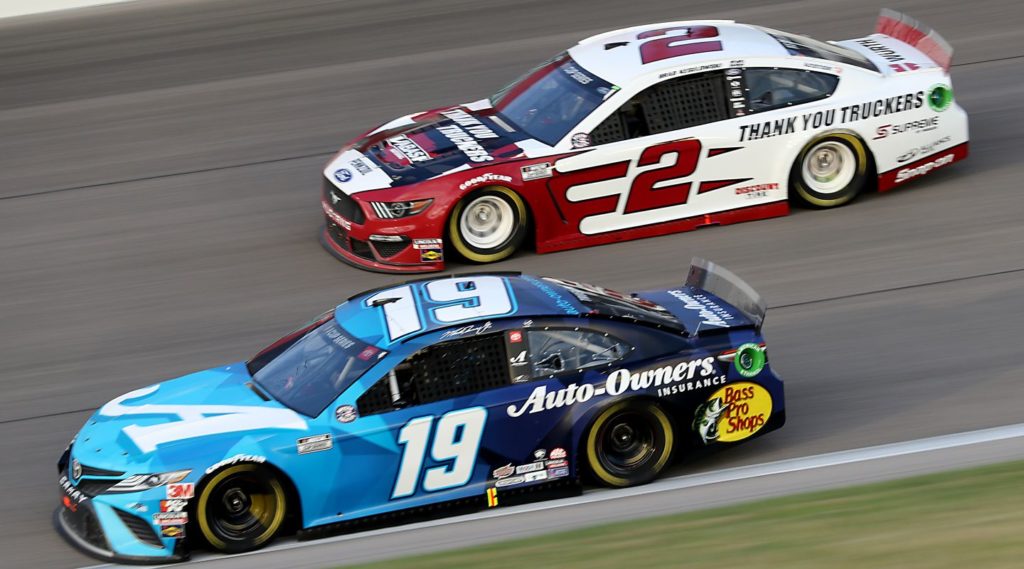 Martin Truex, Jr. and Brad Keselowski racing side-by-side at Kansas