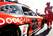 The 150/1 Prop Bet For NASCAR at Road America To Place Now Bubba Wallace waving to fans in front of #23 Doordash Toyota