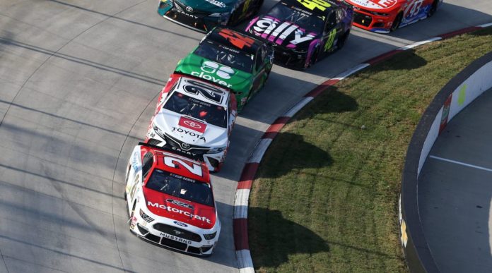 Matt DiBenedetto and others go through turn 1 at Martinsville Speedway