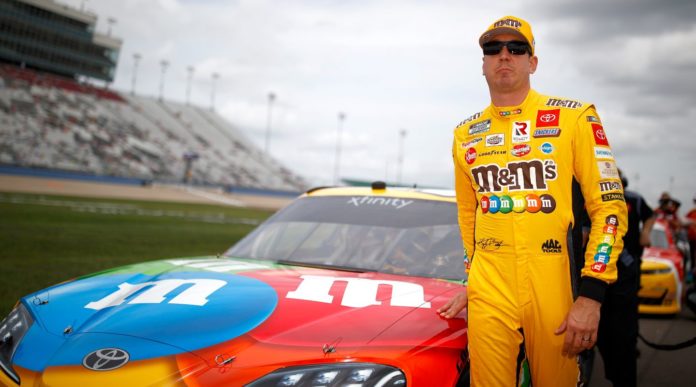 Kyle Busch in front of his M&Ms Toyota before winning his 100th Xfinity race