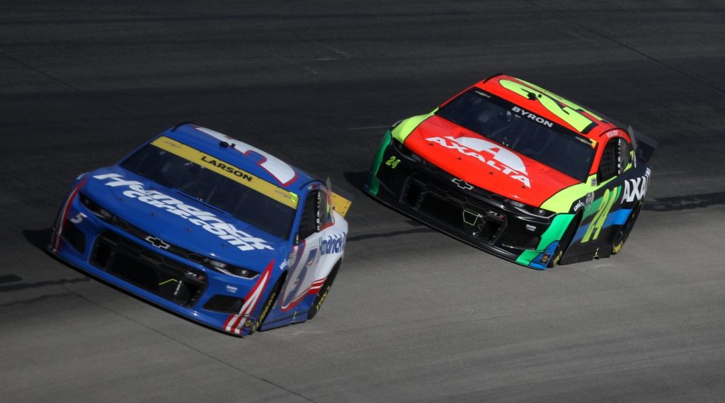 Kyle Larson, driver of the #5 HendrickCars.com Chevrolet, and William Byron, driver of the #24 Axalta Chevrolet, race during the NASCAR Cup Series Autotrader EchoPark Automotive 500 at Texas Motor Speedway on October 17, 2021 in Fort Worth, Texas.