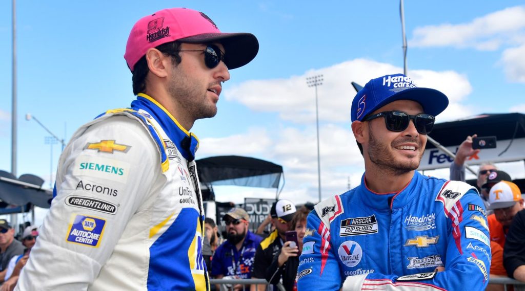 Chase Elliott, driver of the #9 NAPA Auto Parts Chevrolet, (L) and Kyle Larson, driver of the #5 HendrickCars.com Chevrolet, talk on the grid prior to the NASCAR Cup Series Xfinity 500 at Martinsville Speedway on October 31, 2021 in Martinsville, Virginia.
