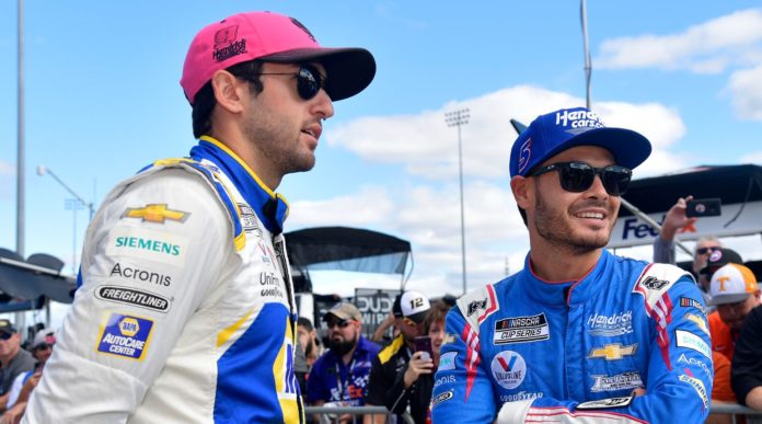 Chase Elliott, driver of the #9 NAPA Auto Parts Chevrolet, (L) and Kyle Larson, driver of the #5 HendrickCars.com Chevrolet, talk on the grid prior to the NASCAR Cup Series Xfinity 500 at Martinsville Speedway on October 31, 2021 in Martinsville, Virginia.